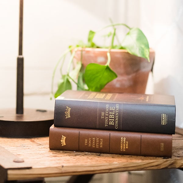 Tony Evans Bible Commentary and Study Bible on side table.