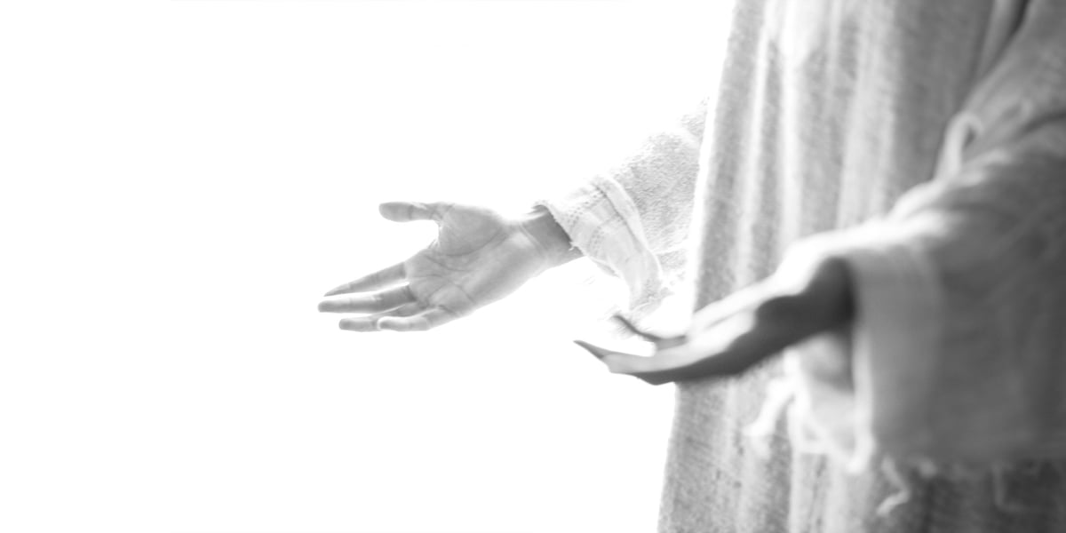 Jesus standing with open hands.